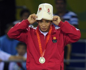 Silevr medallist Kanatbek Begaliev of Kyrgyzstan pulls his hat at the medal ceremony of the men's 66kg Greco-Roman wrestling at the Beijing 2008 Olympic Games August 13, 2008. REUTERS/Dylan Martinez (CHINA)