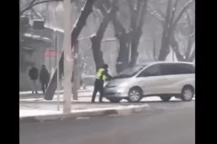 В Бишкеке пьяный водитель провез сотрудника ГУОБДД на капоте